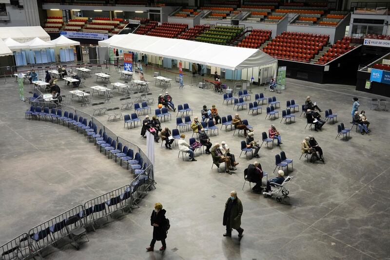 People wait after receiving the vaccine in a vaccination center of Lyon, central France. AP Photo