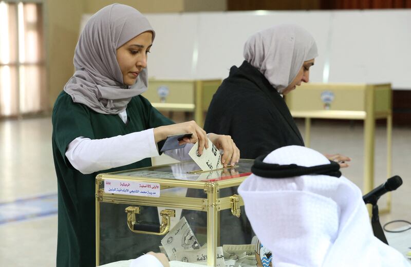 Kuwaiti women cast their votes during parliamentary elections in Kuwait City. Kuwait is holding its most inclusive elections in a decade, with some opposition groups ending a boycott after the country's royal rulers pledged not to interfere with Parliament. AFP