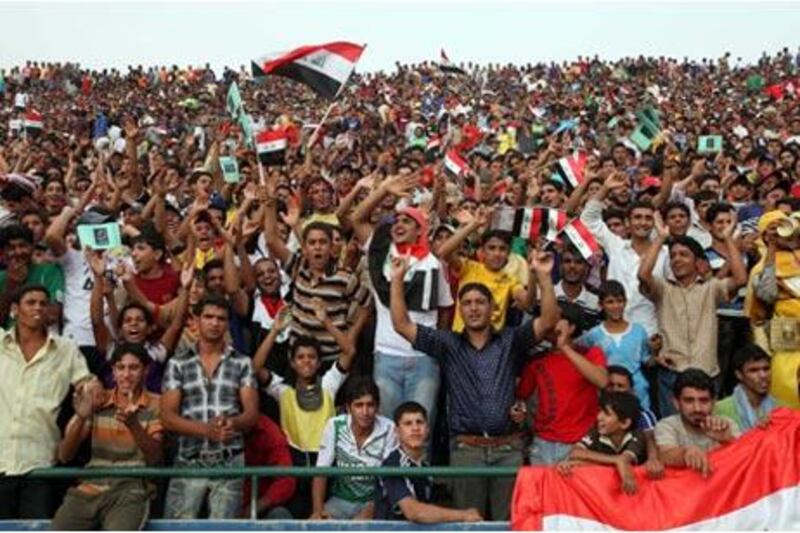 Fans cheer during the match  between Iraq and Palestine on Monday, the first international in Baghdad since the  2003 invasion.