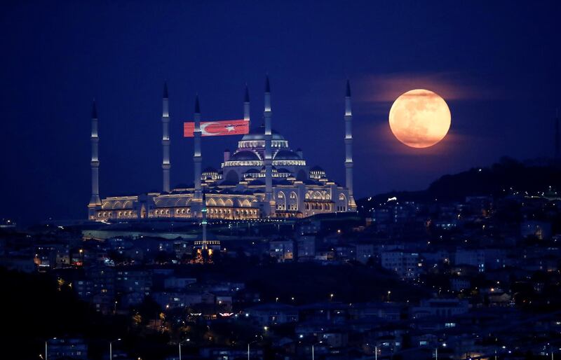 The full Moon rises above the Camlica Mosque in Istanbul, Turkey. Reuters