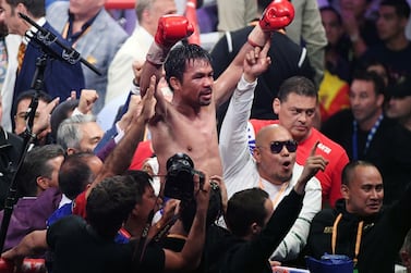 (FILES) In this file photo taken on July 20, 2019 Manny Pacquiao celebrates his split-decision victory over Keith Thurman in their WBA welterweight title fight at MGM Grand Garden Arena on in Las Vegas, Nevada. Manny Pacquiao is mulling a possible fight with Irish mixed martial arts star Conor McGregor as he plots his return to the ring, representatives for the Filipino boxing icon told AFP on September 25, 2020. / AFP / GETTY IMAGES NORTH AMERICA / Ethan Miller