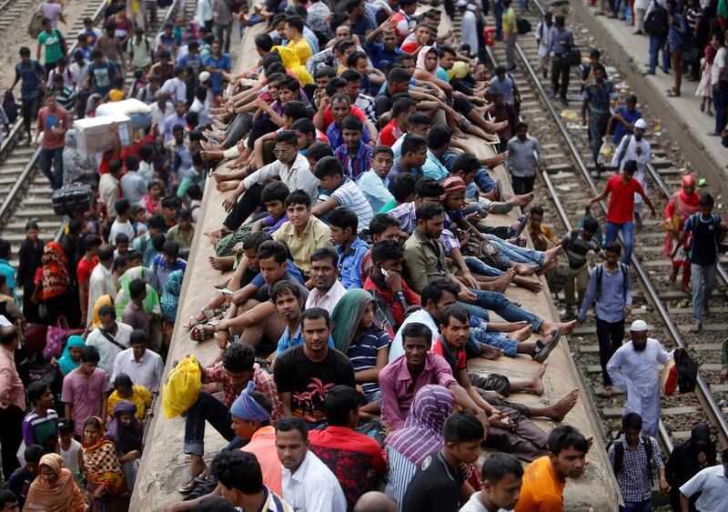 People sit atop an overcrowded passenger train in Dhaka, Bangladesh, on September 9, 2016, as they travel home to celebrate the Eid Al Adha festival,. Mohammad Ponir Hossain / Reuters