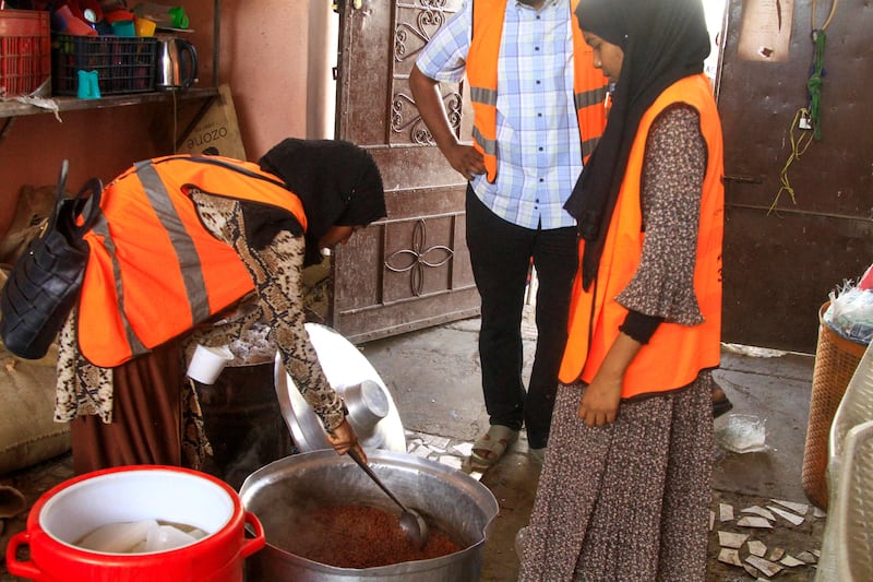 Volunteers prepare food for displaced people to break their fast in Al Qadarif, eastern Sudan. The country is experiencing its second consecutive Ramadan in the grip of conflict. AFP