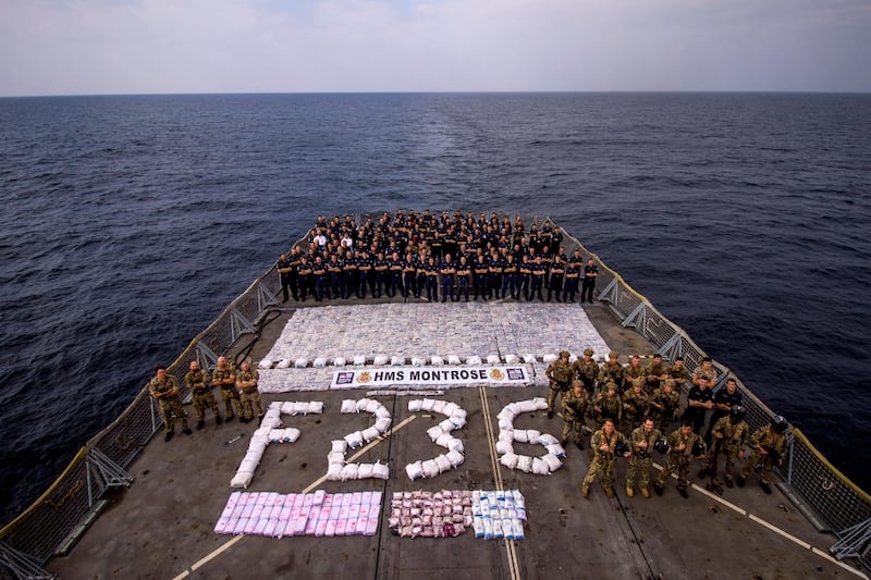 HMS Montrose ship’s company assemble on the flight deck with a large quantity of narcotics seized from a dhow in the Arabian Gulf. (Photo: LS(EW) Parsons RN)