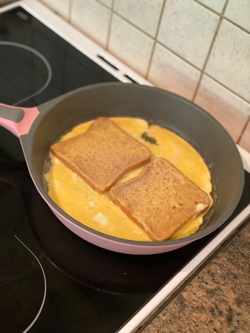 Dip the bread in the still-liquid egg and then flip it, using your spatula or very carefully with your fingers - don't burn yourself! You want to make sure the top of the bread is coated with egg. Farah Andrews / The National