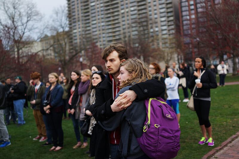 BOSTON, MA - APRIL 16: A couple hugs during a vigil for victims of the Boston Marathon bombings at Boston Commons on April 16, 2013 in Boston, Massachusetts. The twin bombings, which occurred near the marathon finish line, resulted in the deaths of three people while hospitalizing at least 140. The bombings at the 116-year-old Boston race, resulted in heightened security across the nation with cancellations of many professional sporting events as authorities search for a motive to the violence.   Spencer Platt/Getty Images/AFP== FOR NEWSPAPERS, INTERNET, TELCOS & TELEVISION USE ONLY ==
 *** Local Caption ***  925919-01-09.jpg