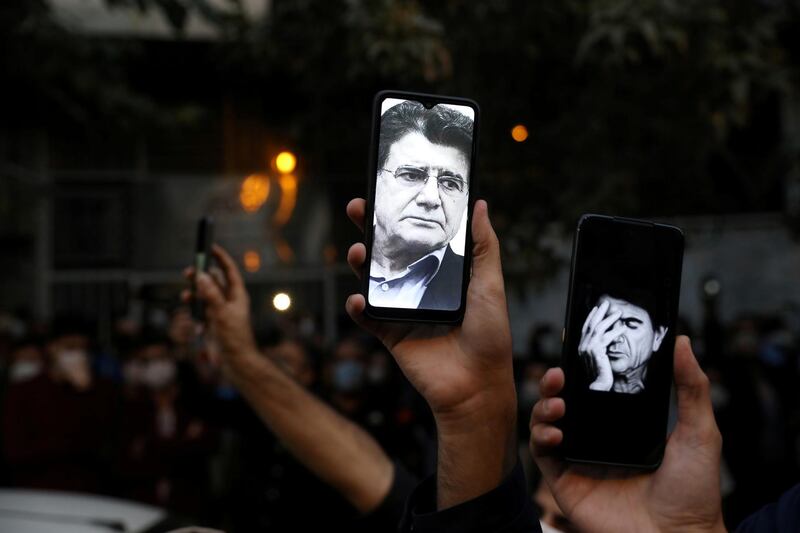 Photos of Mohammad Reza Shajarian are seen on fans' smartphones as they mourn his death. Reuters