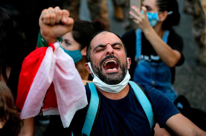A Lebanese protester shouts slogans during a demonstration against the lack of progress in a probe by authorities into a monster blast that ravaged swathes of the capital 40 days ago, near the presidential palace in Baabda, east of the capital Beirut.  AFP