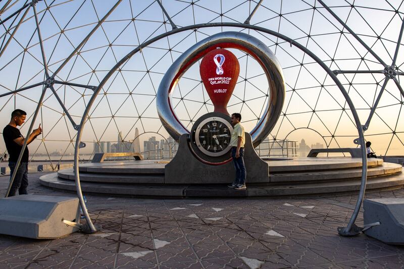 Visitors take photographs alongside Fifa World Cup countdown installation. Bloomberg