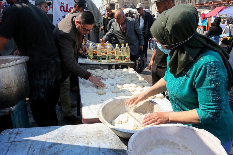 Iraqi protesters prepare sweets at Baghdad's Tahrir Square. AFP