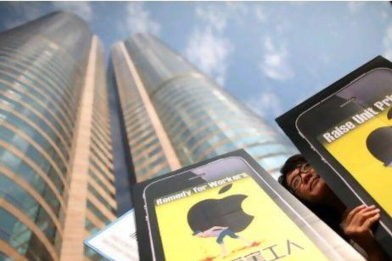 A woman holds a banner outside the Hong Kong stock exchange calling for better conditions for factory workers. AFP PHOTO / ED JONES