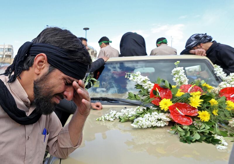 An Iranian man cries during the funeral of 27 Revolutionary Guards, who were killed in a suicide attack, in southeastern city of Isfahan on February 16, 2019. Iran's Revolutionary Guards accused "Pakistan's security forces" of supporting the perpetrators of a suicide bombing that killed 27 troops on February 13, in remarks state TV aired. / AFP / ATTA KENARE
