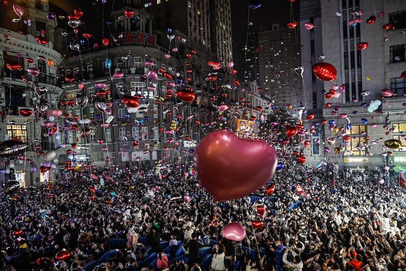 Revellers release balloons in Wuhan, China. Getty