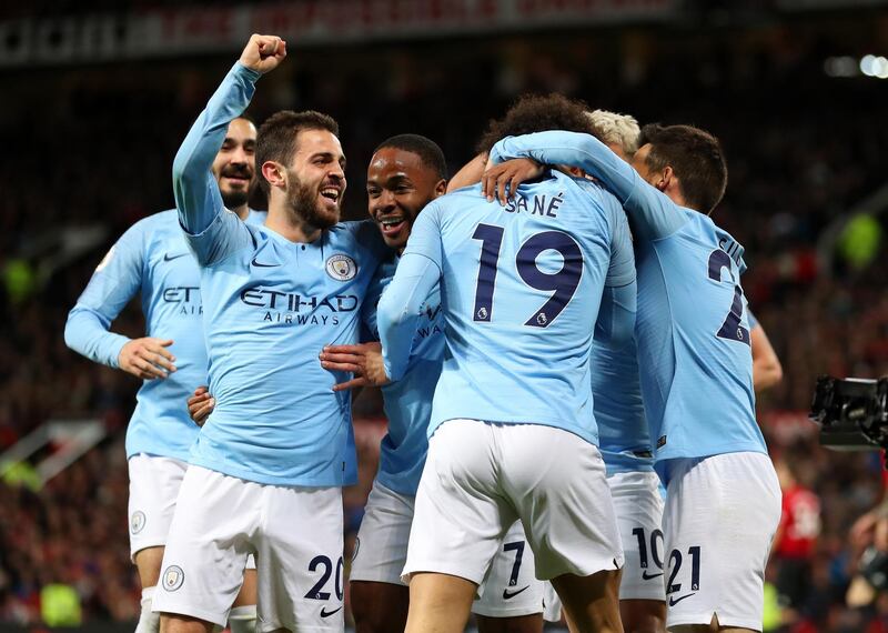 Manchester City's Leroy Sane celebrates with teammates after scoring his team's second goal. Catherine Ivill / Getty Images