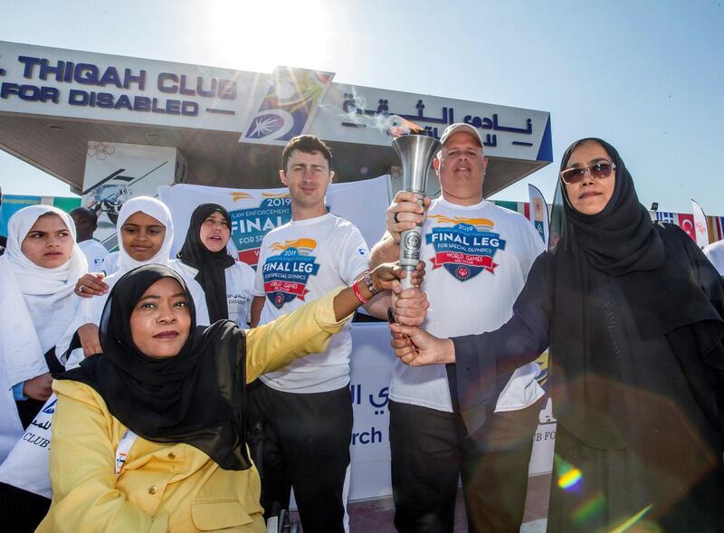 DUBAI, UNITED ARAB EMIRATES - The Special Olympics Torch being held by officials and participants at the Special Olympics Torch Run at Al Thiqah Club for Handicapped.  Leslie Pableo for The National