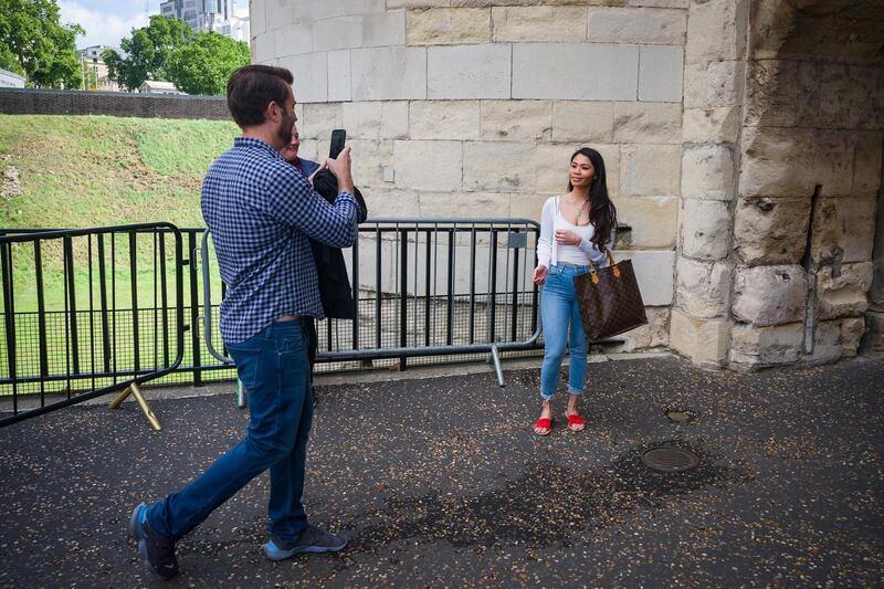 The first two tourists take a photograph as they pass under the Middle Tower. Getty Images