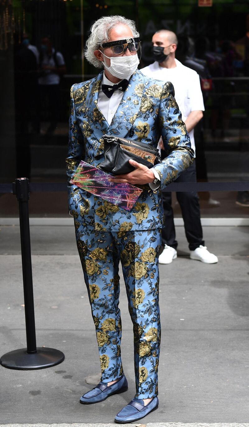 A guest arrives at the Dolce & Gabbana show during Milan Men's Fashion Week on June 19, 2021 in Milan, Italy. AFP