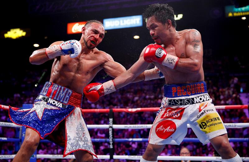 Keith Thurman, left, and Manny Pacquiao exchange punches in the eighth round. AP Photo