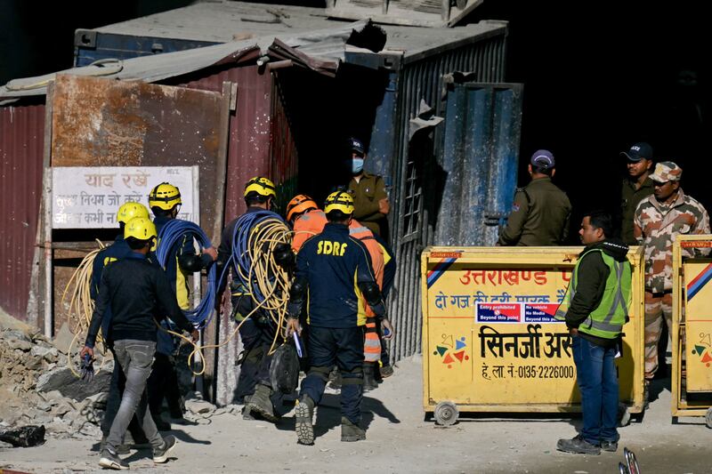 Rescue personnel enter the tunnel, which collapsed during construction work on November 12. AFP