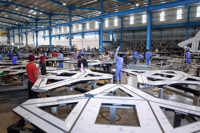 ABU DHABI, UNITED ARAB EMIRATES, Jan. 19, 2015:  
Laborers work with aluminium extrusions, which clip together to form the 'stars' that will become cladding pieces for the Louvre Abu Dhabi dome, on Monday, Jan. 19, 2015, at the White Aluminium fabrication plant in Musaffah, Abu Dhabi. (Silvia Razgova / The National)  /  Usage:  undated, RESTRICTED /  Section: NA   /  Reporter:  Nick Leech *** Local Caption ***  SR-150119-LAD0103.jpg SR-150119-LAD0103.jpg