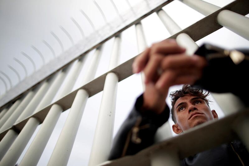 A migrant waits at the bridge. Reuters