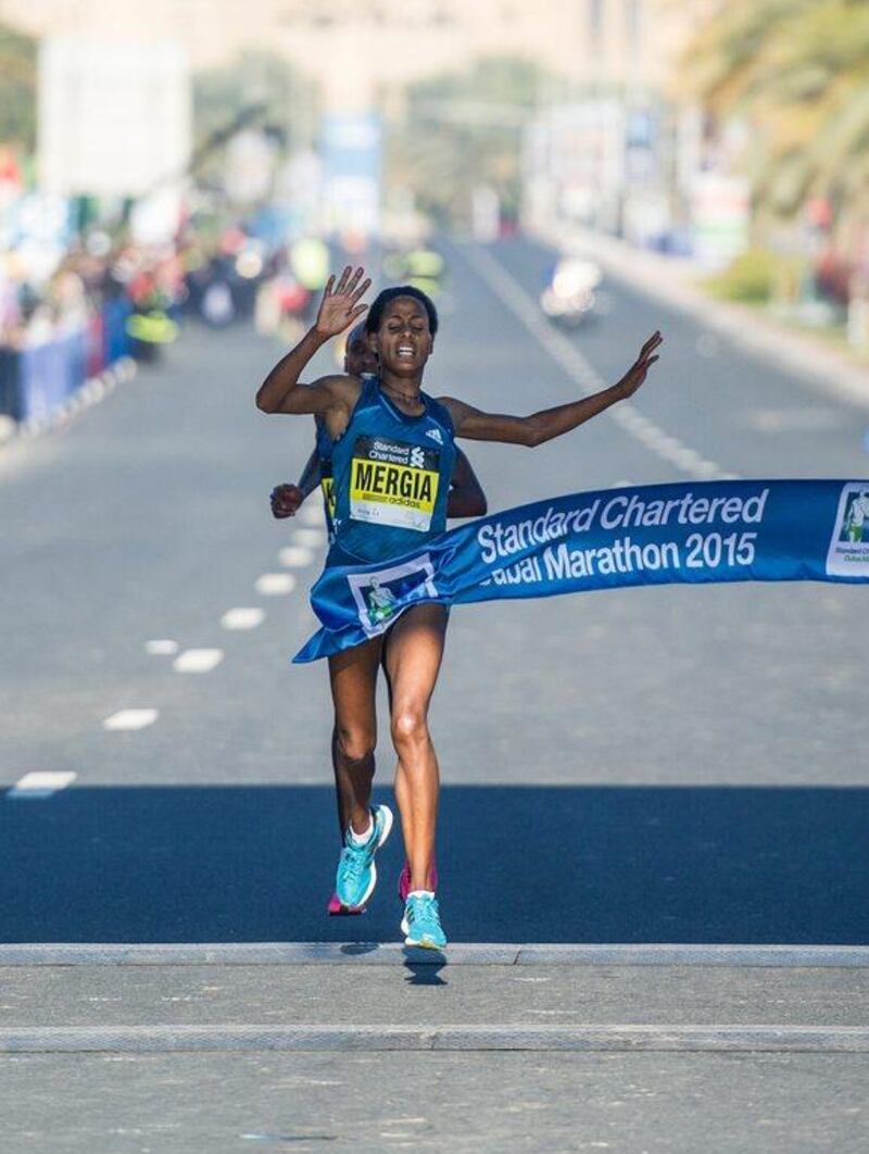 Aselefech Mergia crosses the finish line to win the Dubai Marathon on Friday. Stephen Hindley / AP