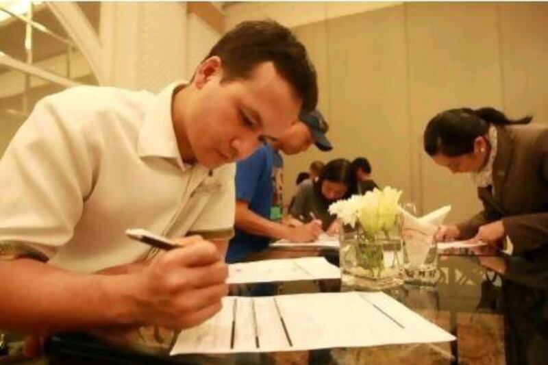 Joel Berina Favia and Maria Aiza Agustin register during an absentee voting registration session at the Sheraton Hotel in Abu Dhabi.