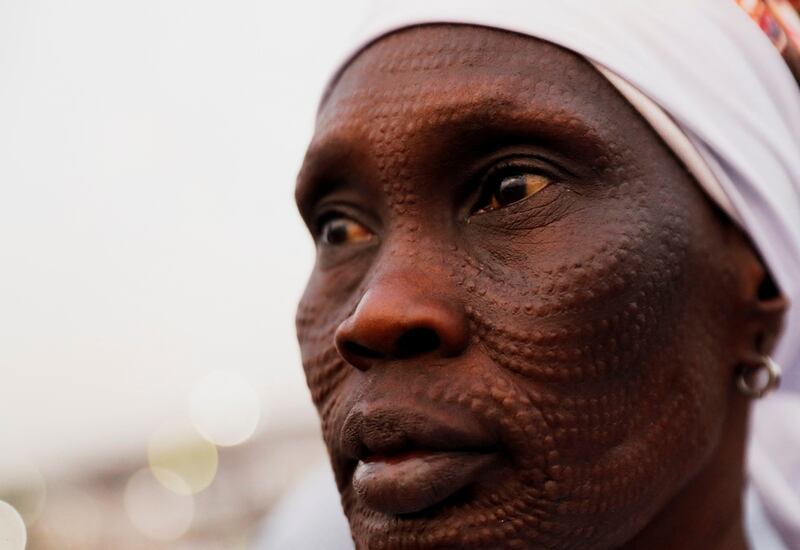 A worshipper waits for the Pope to lead mass. Reuters