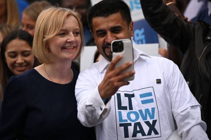 Ms Truss poses for a selfie with a supporter as she arrives for the event in Manchester. Getty