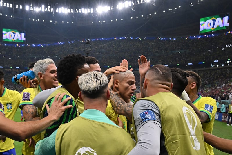 Brazil forward Richarlison (C) celebrates with teammates after scoring the second goal in the 2-0 win against Serbia at the Lusail Stadium on November 24, 2022. AFP