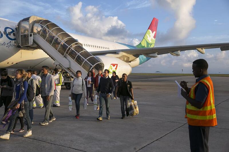 Passengers disembark an Air Seychelles plane at Victoria airport. Silvia Razgova / The National