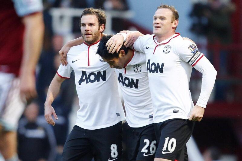 From left to right, Juan Mata, Shinji Kagawa and Wayne Rooney of Manchester United celebrate a goal during Saturday's win over West Ham. Tal Cohen / EPA / March 22, 2014  
