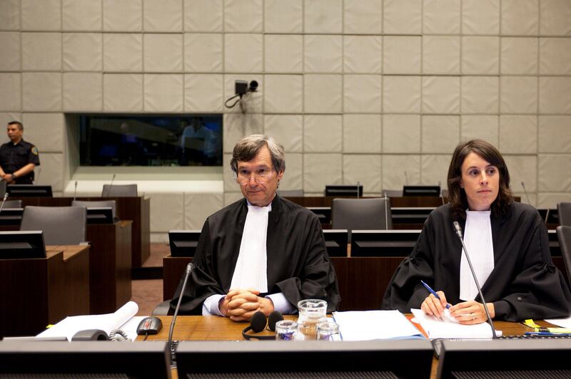 Francois Roux (L), Head of Defence Office, sits beside Anne-Marie Burns, Associate Legal Officer, in the courtroom of the Special Tribunal for Lebanon in The Hague, Netherlands, July 13, 2010. The United Nations' Special Tribunal for Lebanon opened its first public hearing on Tuesday, as a former Lebanese general sought the right to request information from the court in support of a libel case.   REUTERS/Valerie Kuipers/Pool    (NETHERLANDS - Tags: POLITICS)