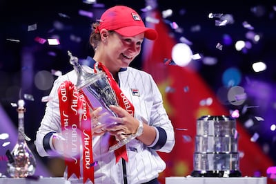 Ashleigh Barty of Australia holds her trophy while being showered by confetti after winning the WTA Finals Tennis Tournament against Elina Svitolina of Ukraine at the Shenzhen Bay Sports Center in Shenzhen, China's Guangdong province, Sunday, Nov. 3, 2019. (AP Photo/Andy Wong)
