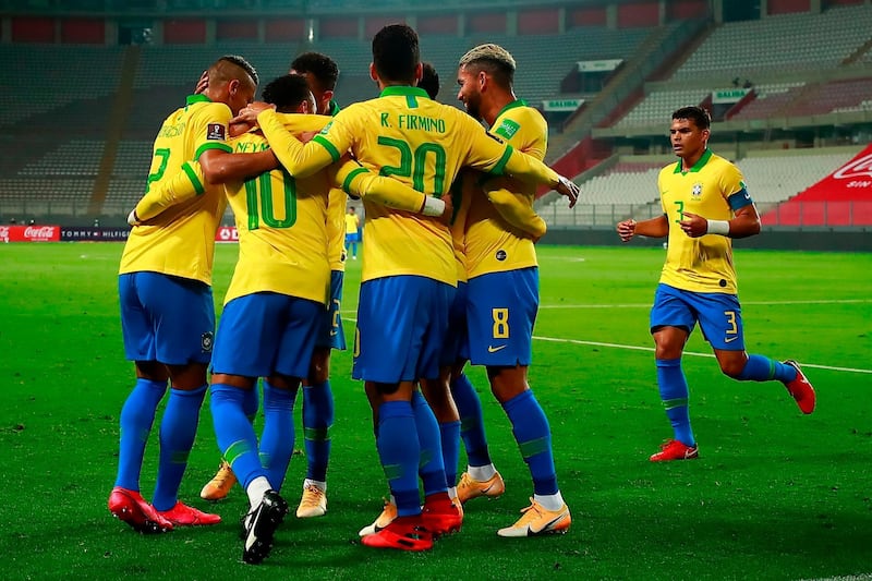 Neymar (2-L) celebrates with teammates after scoring against Peru. AFP