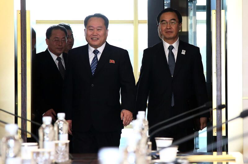 South Korean unification minister Cho Myoung-gyon (R) and head of North Korean delegation Ri Son Gwon (L) walk into a meeting room before their meeting at the Panmunjom in the Demilitarised Zone on January 9, 2018. Getty Images