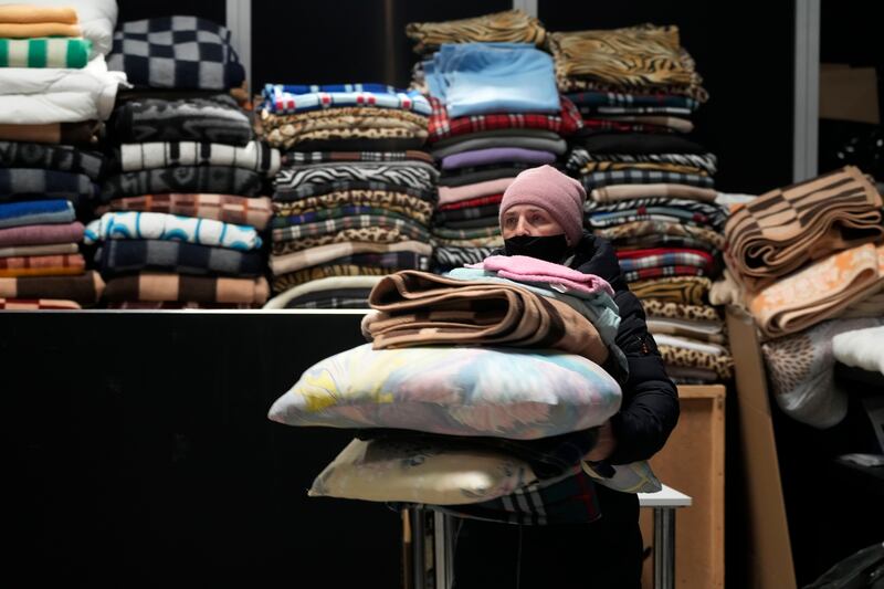A Ukrainian refugee with pillows and blankets at a centre in Nadarzyn, near Warsaw, Poland. AP