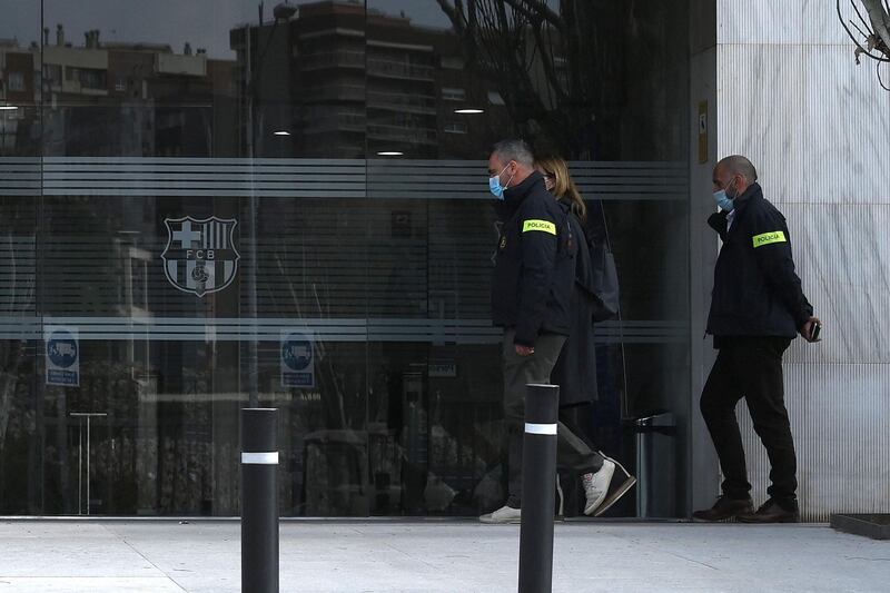 Police officers enter the offices of Barcelona football club. AFP