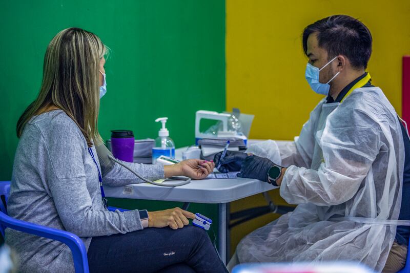 A blood pressure check before receiving the coronavirus vaccine in Abu Dhabi. Photo: Abu Dhabi Department of Education and Knowledge