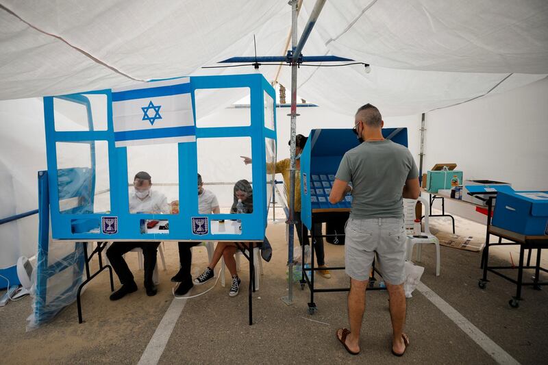 A man prepares to cast his ballot at a special mobile polling station near a beach in Ashdod. Reuters