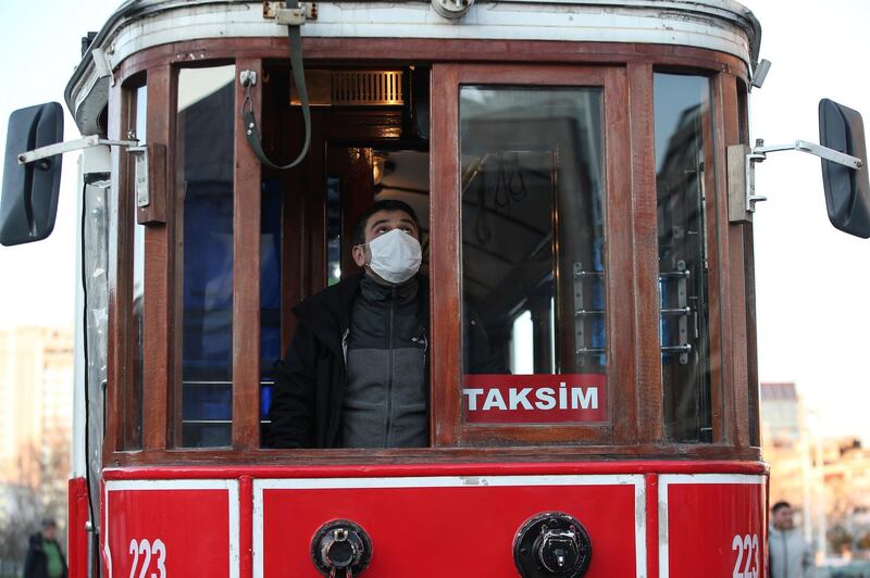 A driver wearing a protective mask drives a tram along Istiklal street, the main shopping street in Istanbul, amid the coronavirus outbreak, in Turkey. AP Photo