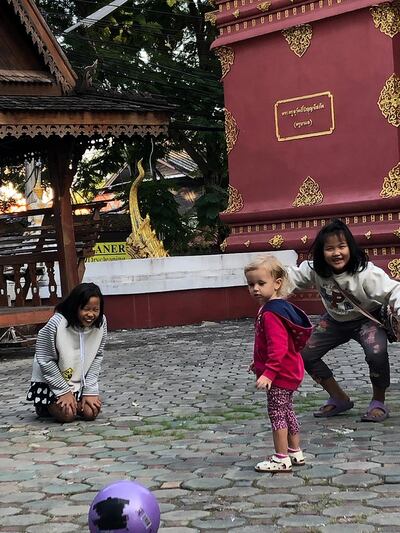 Carmen playing with some Thai children at a temple in Chiang Mai. Courtesy Emmanuel Samoglou