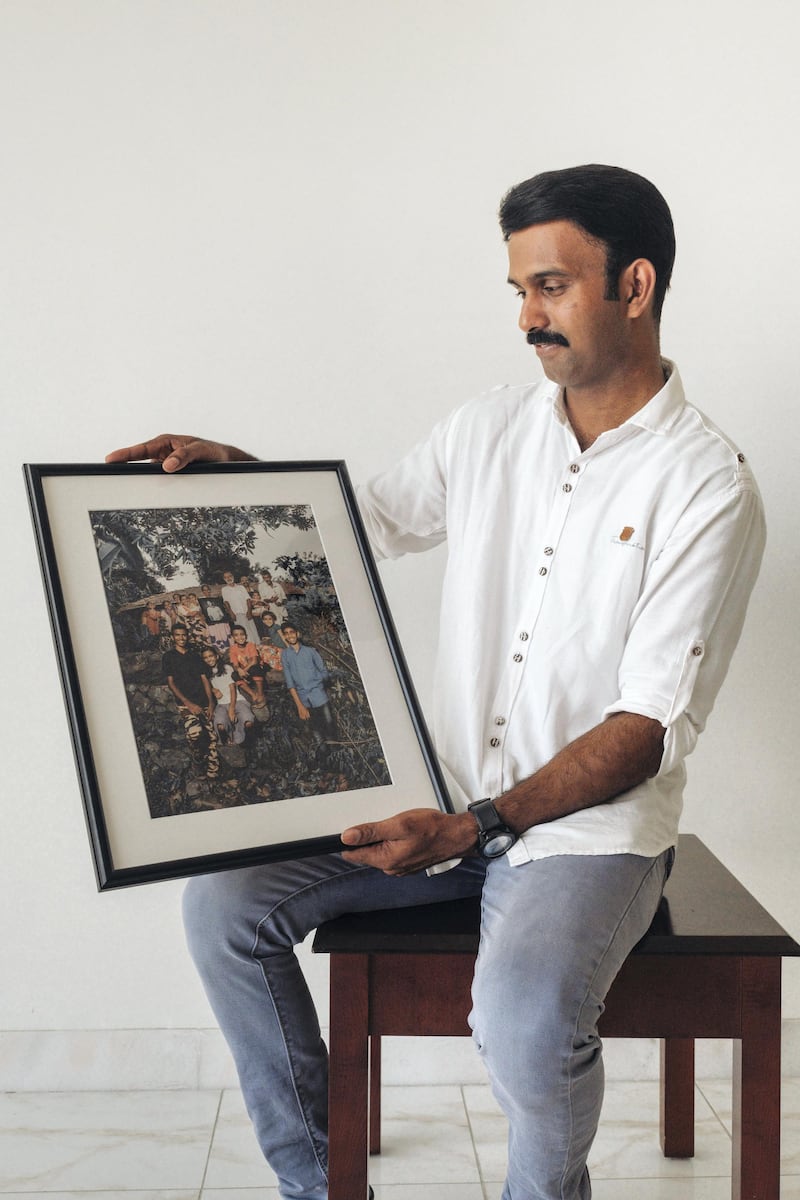 Jomy Joseph receives the picture of his family with the portrait of him as part of the Father’s Day Project. Courtesy: Waleed Shah and Nikith Nath