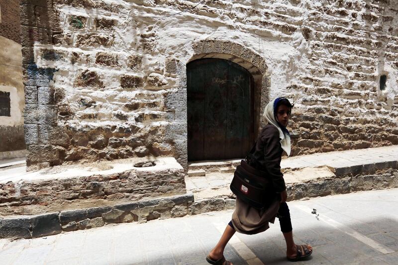A Yemeni passes a historic building in the old city of Sanaa, Yemen. EPA
