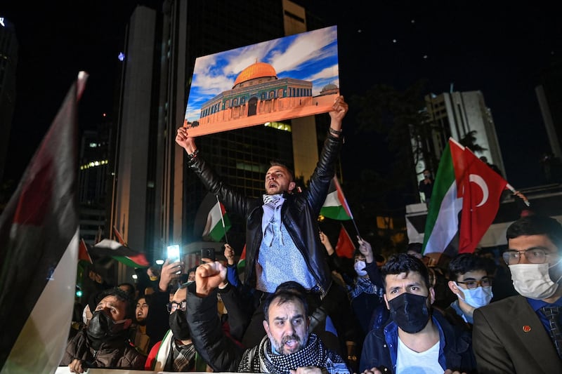 A protester holds a poster of Al Aqsa Mosque during a demonstration against Israel in front of the Israeli Consulate in Istanbul. AFP