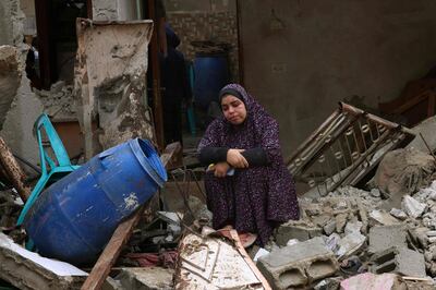 A woman sits in the rubble of southern Gaza. AFP