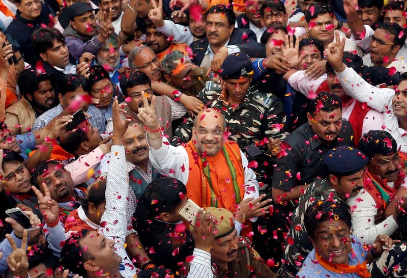 Amit Shah, centre, the president of India’s ruling Bharatiya Janata Party, celebrates with party supporters after learning of the initial poll results inside the party headquarters in New Delhi, India on March 11, 2017. Adnan Abidi / Reuters