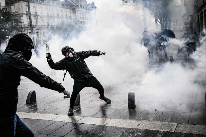 A protester throws a bottle during a demonstration in Nantes. AFP