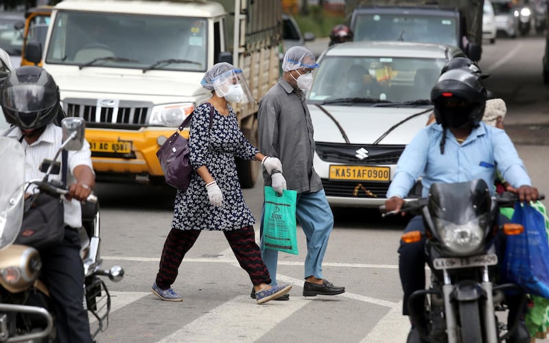 epa08581570 People wear mask to get protected from the novel coronavirus COVID-19, in Bangalore, India, 03 August 2020. India is listed as the third highest country worldwide in regard to total COVID-19 cases after the United States and Brazil.  EPA/JAGADEESH NV