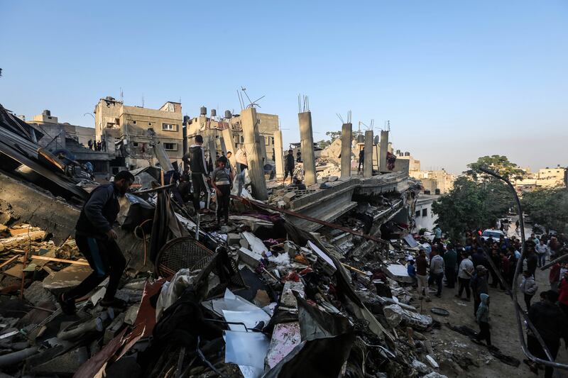 People search through the rubble of buildings destroyed during Israeli air raids in the southern Gaza Strip. Getty Images